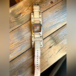 Womens fashion watch on a leather band. Needs new batteries.